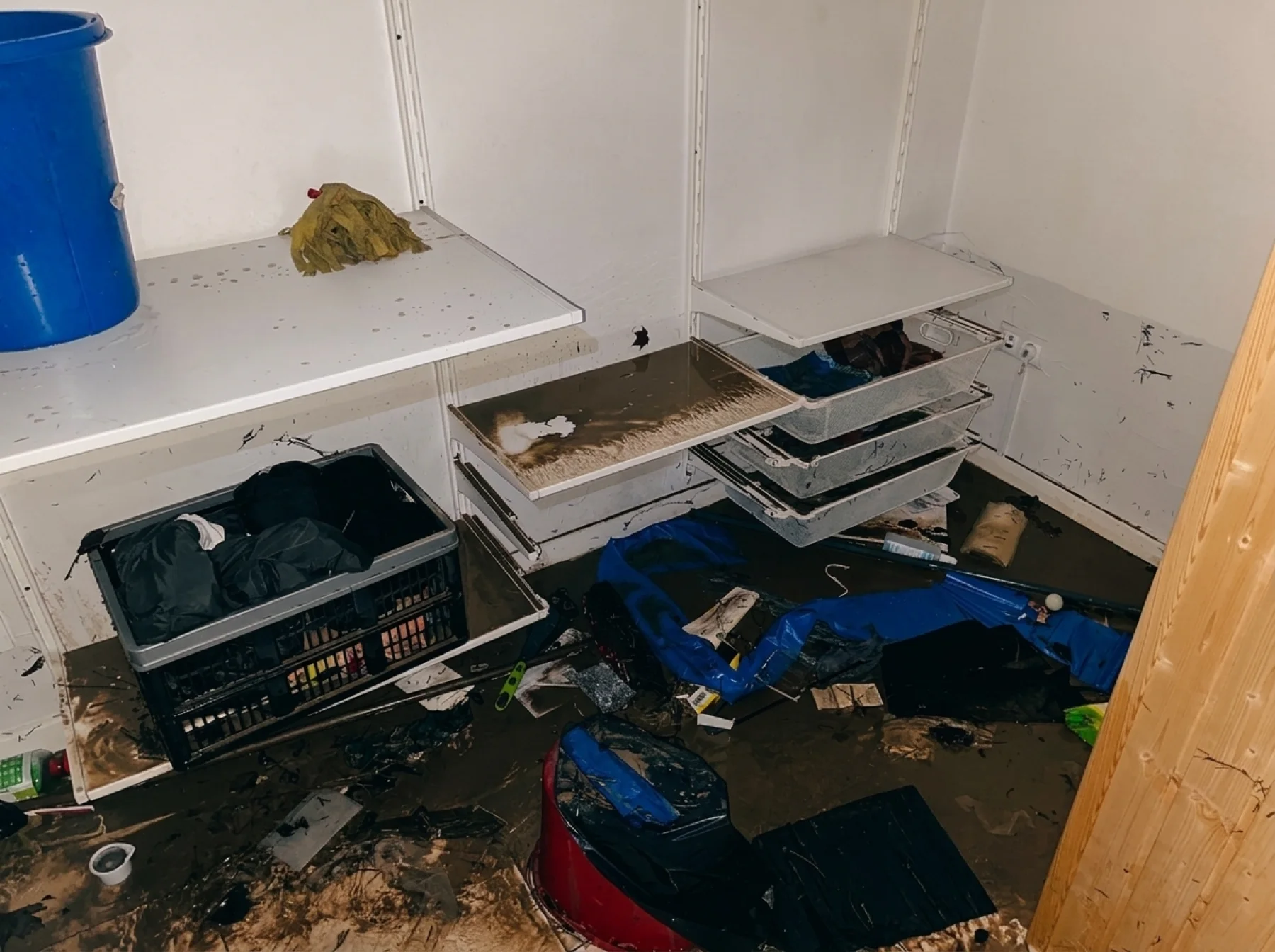 Storage shelves fouled with flood silt and debris.